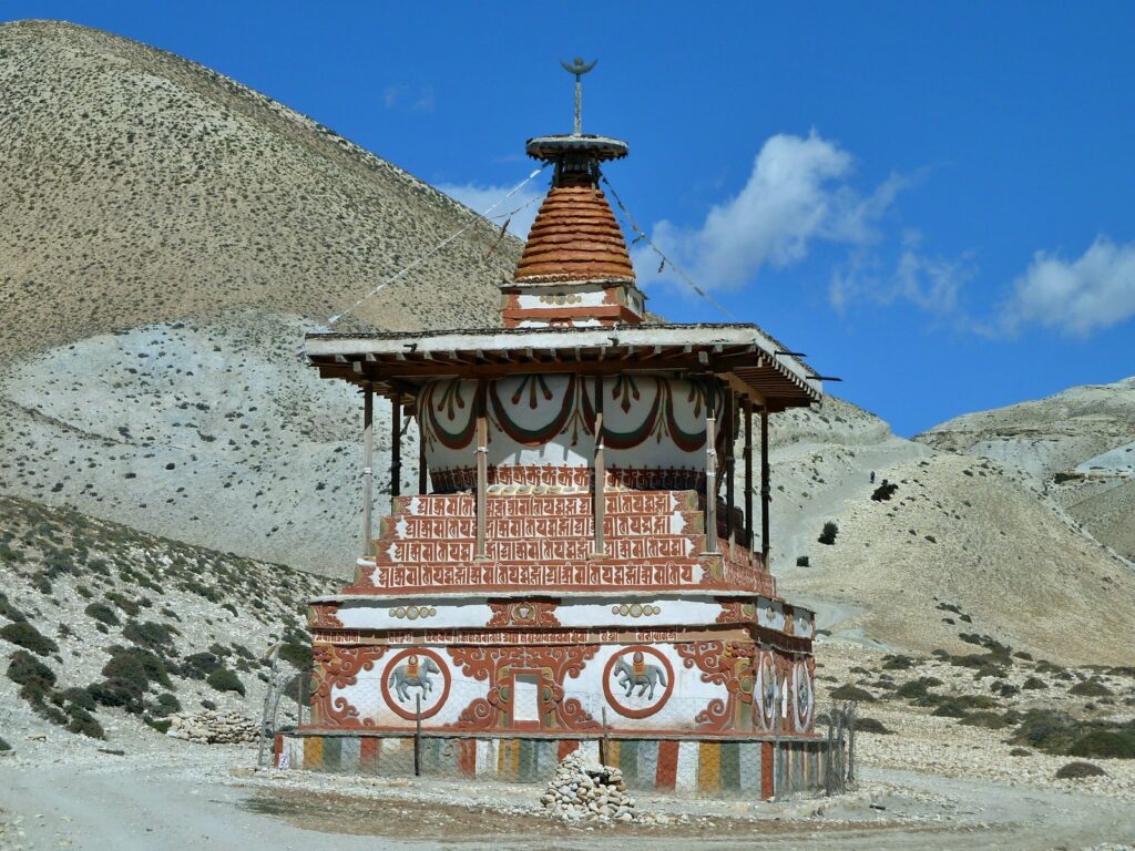 red and yellow temple near mountain under blue sky during daytime