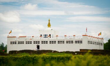 Capture of the iconic Maya Devi Temple in Lumbini, Nepal, set against a vibrant sky.