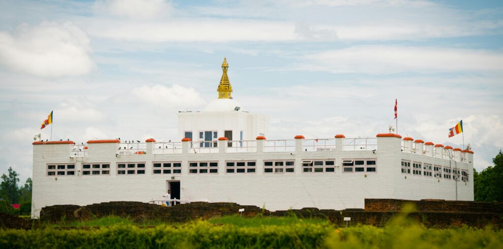 Capture of the iconic Maya Devi Temple in Lumbini, Nepal, set against a vibrant sky.