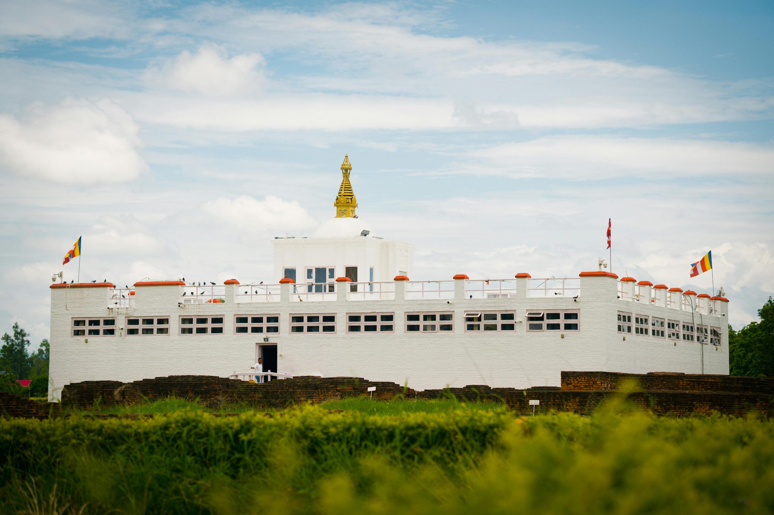 Capture of the iconic Maya Devi Temple in Lumbini, Nepal, set against a vibrant sky.